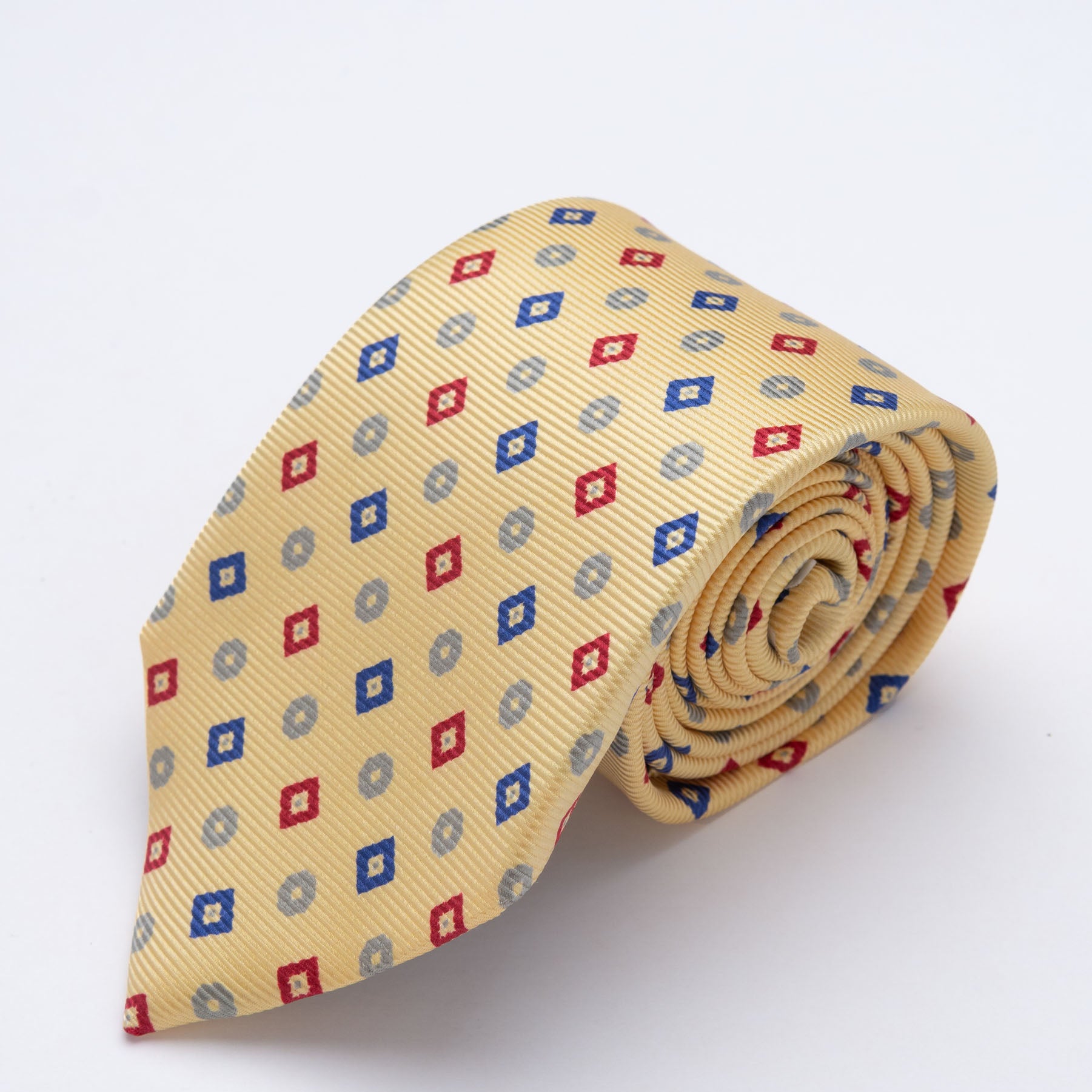CORBATA AMARILLO PASTEL CON ROMBOS ROJOS Y AZULES