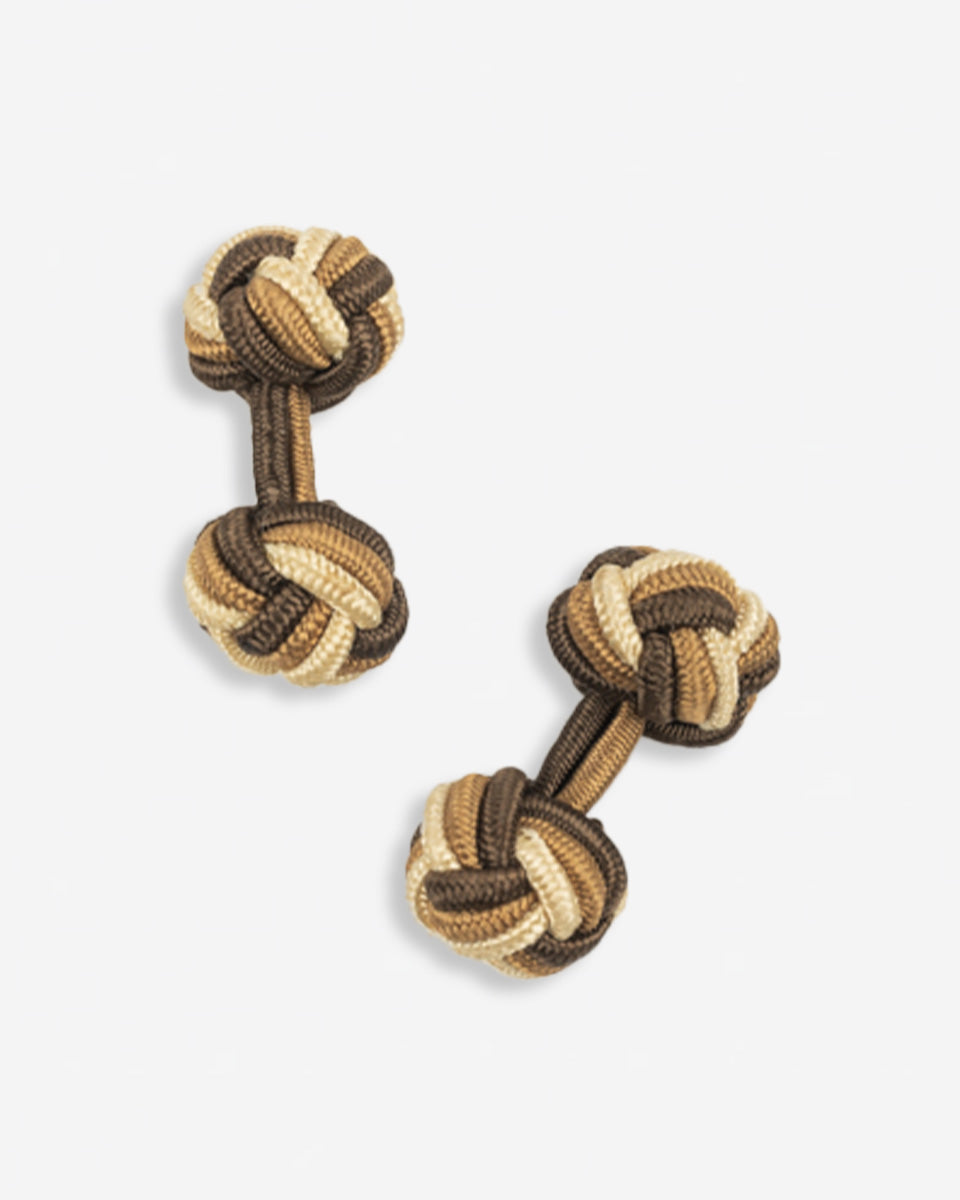 Cufflinks in the shape of a woven knot, made of metal and gold plated
