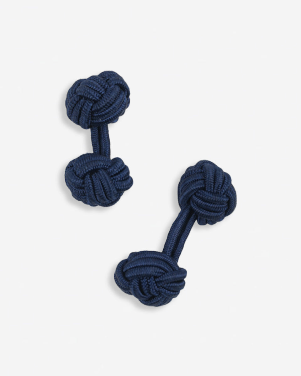 Cufflinks in the shape of a woven knot, made of metal and gold plated
