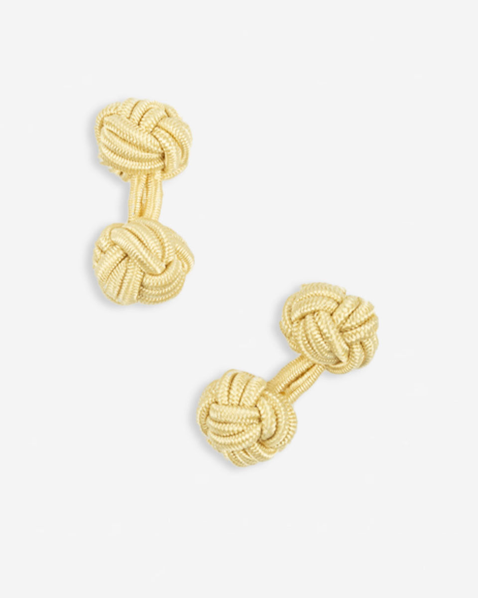 Cufflinks in the shape of a woven knot, made of metal and gold plated