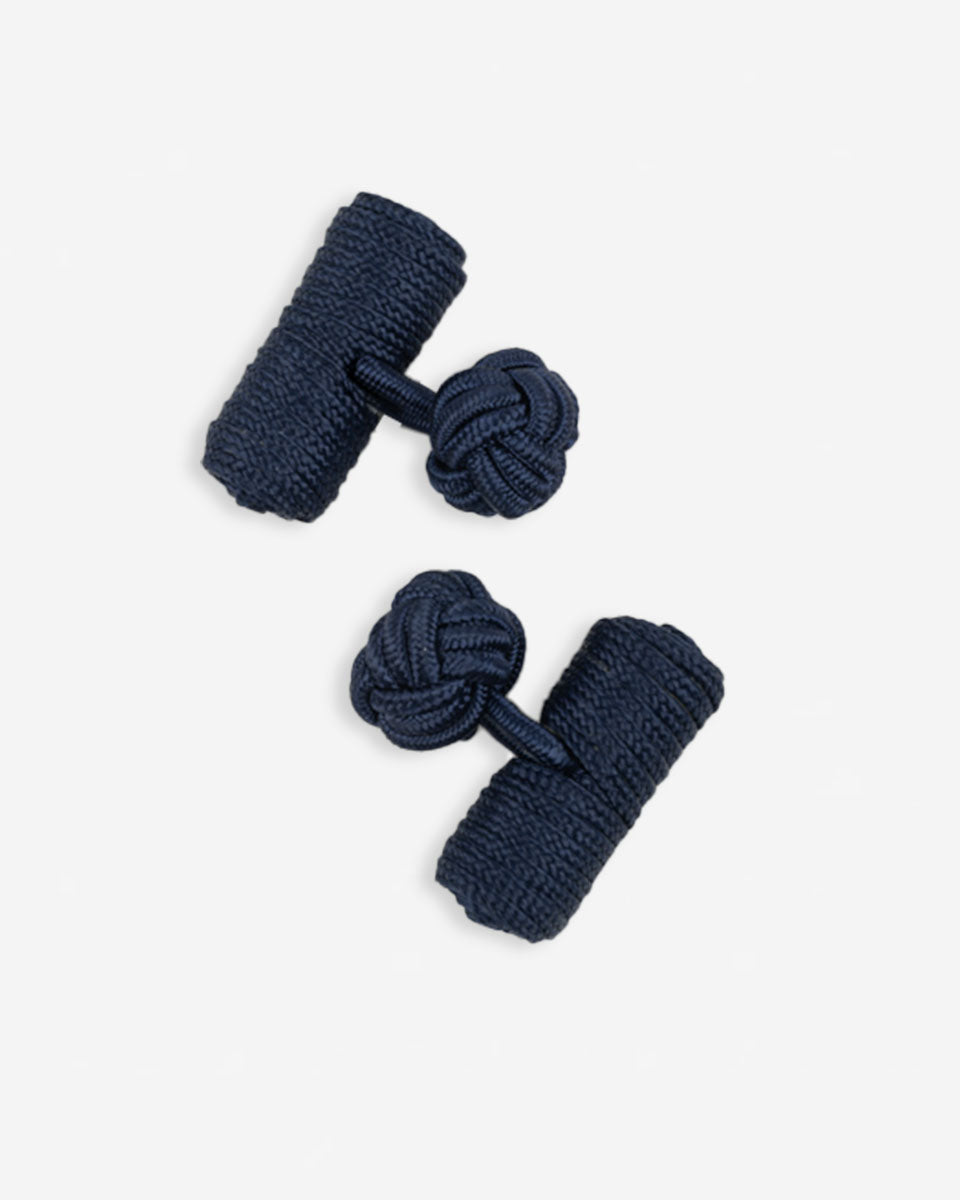 Cufflinks in the shape of a woven knot, made of metal and gold plated