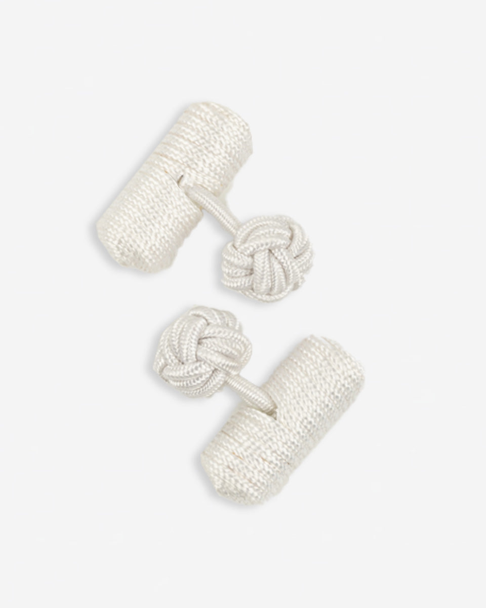 Cufflinks in the shape of a woven knot, made of metal and gold plated