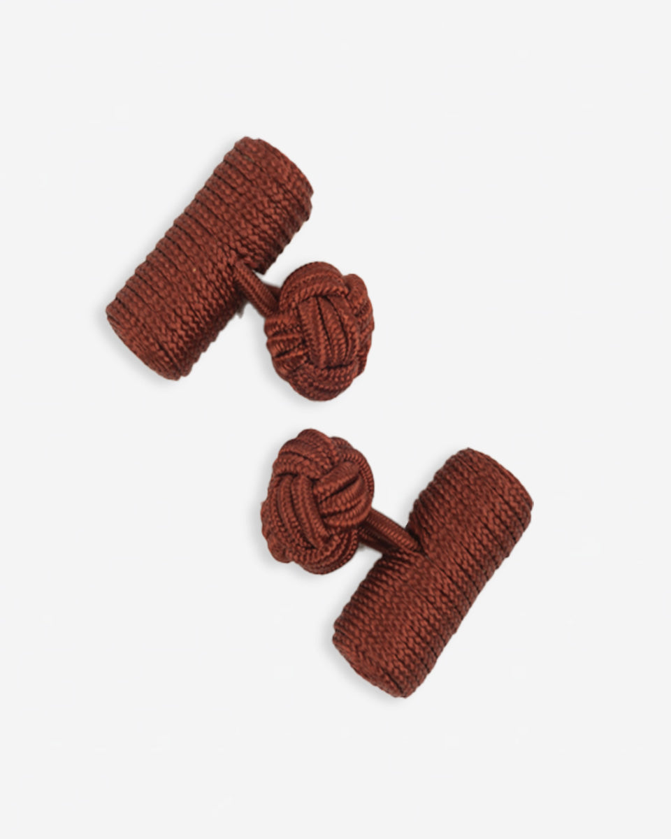 Cufflinks in the shape of a woven knot, made of metal and gold plated