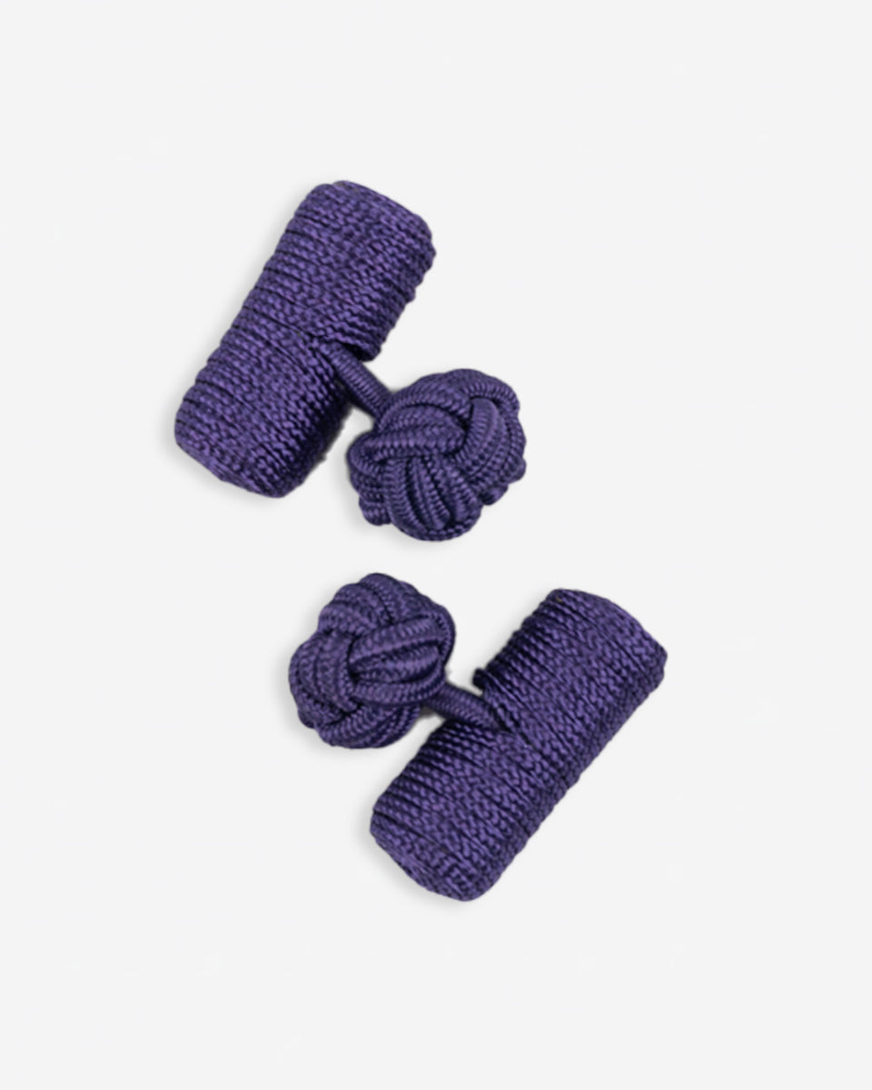 Cufflinks in the shape of a woven knot, made of metal and gold plated