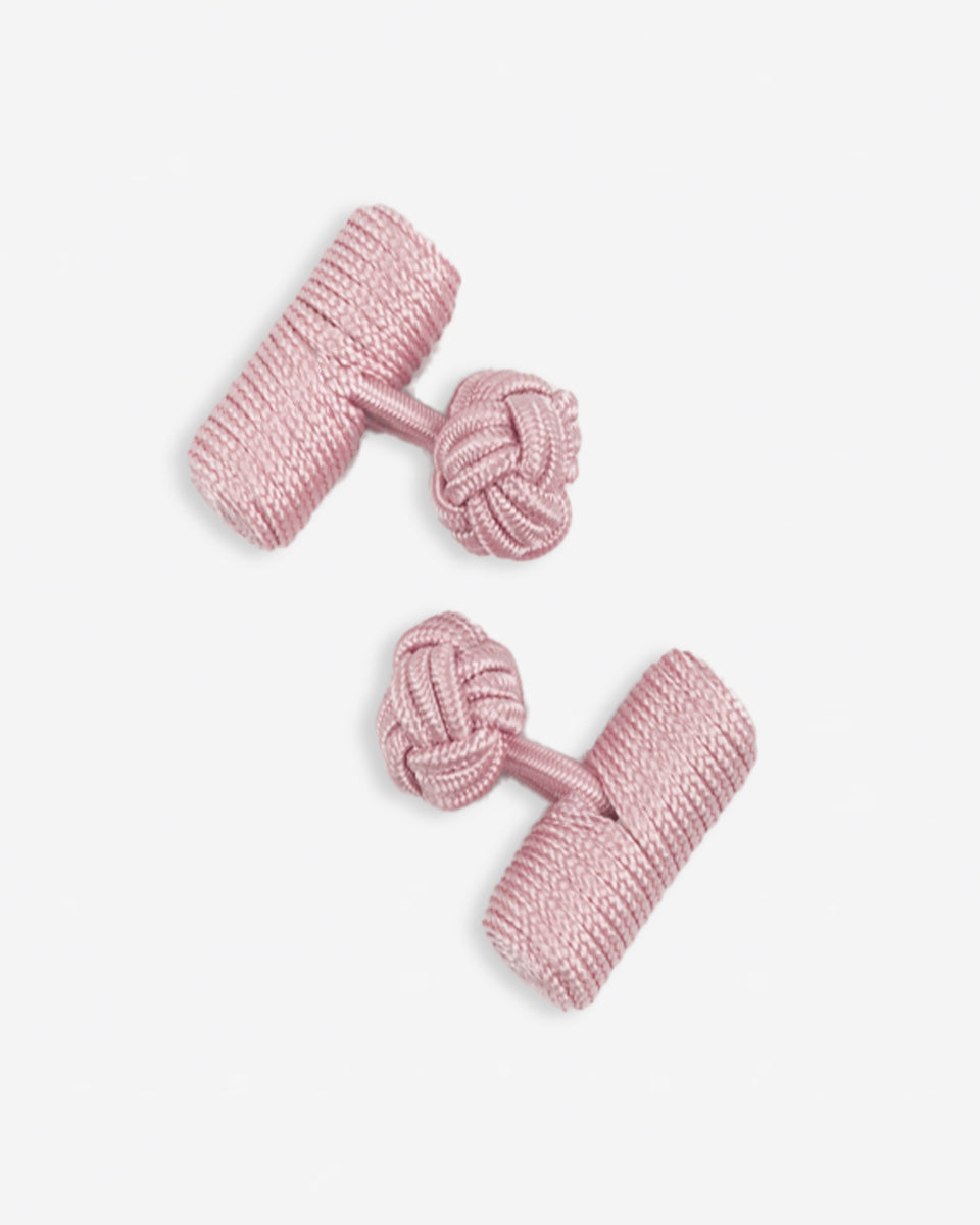 Cufflinks in the shape of a woven knot, made of metal and gold plated