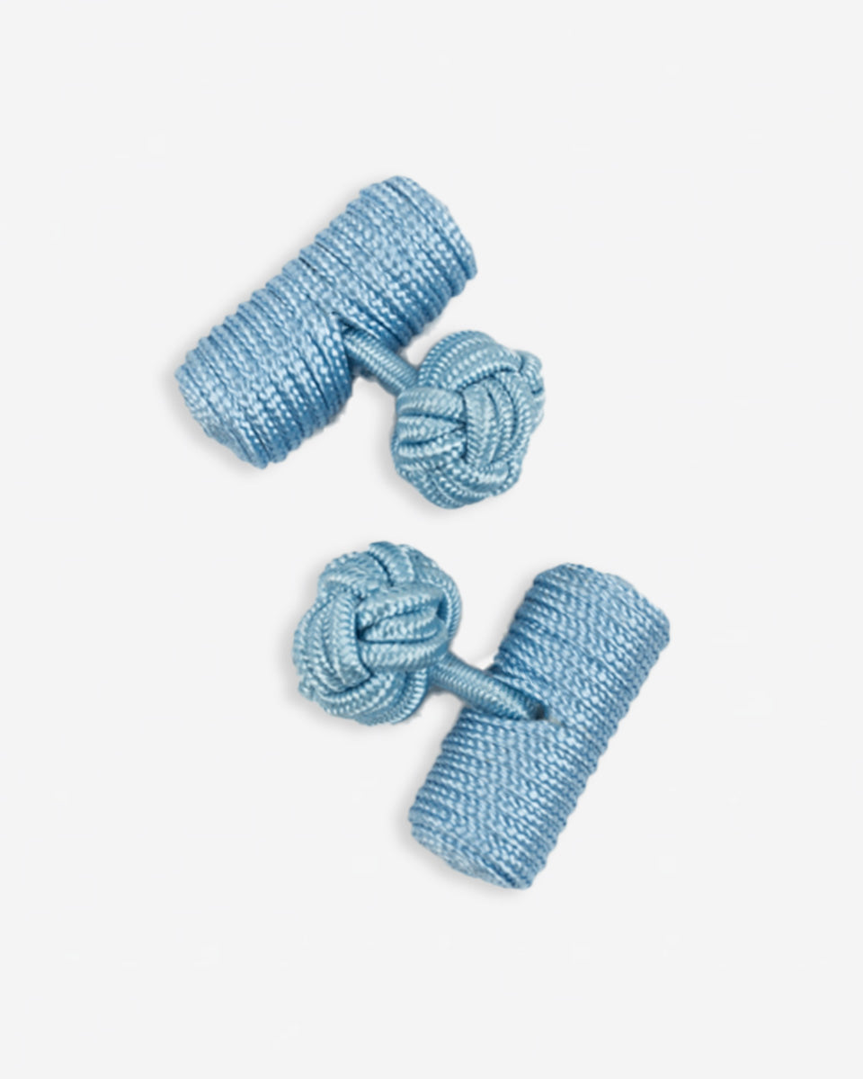 Cufflinks in the shape of a woven knot, made of metal and gold plated