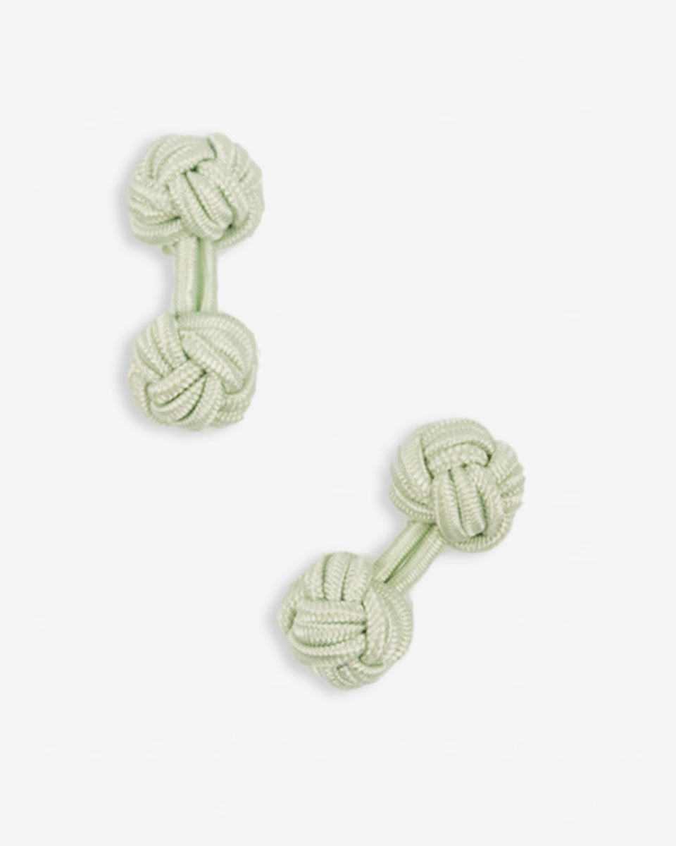 Cufflinks in the shape of a woven knot, made of metal and gold plated