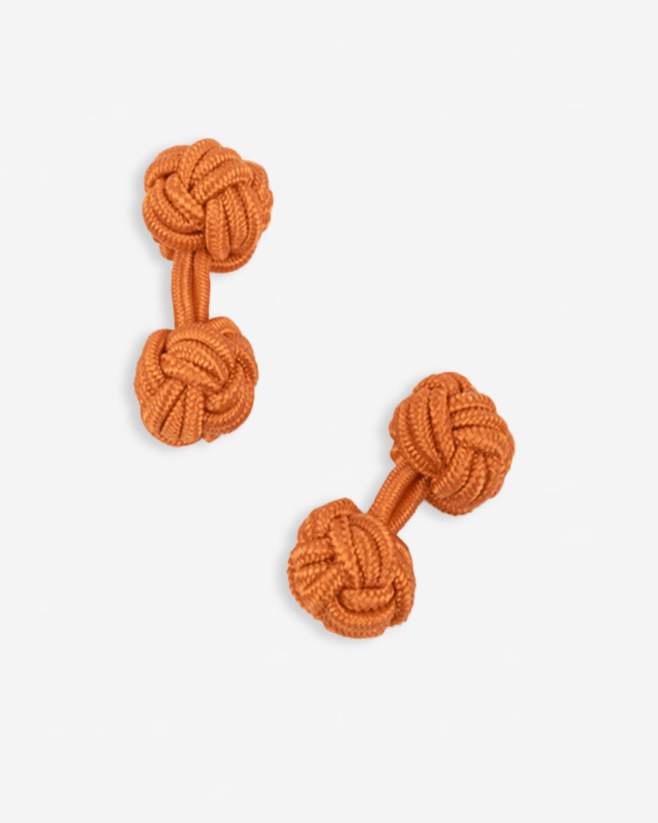 Cufflinks in the shape of a woven knot, made of metal and gold plated